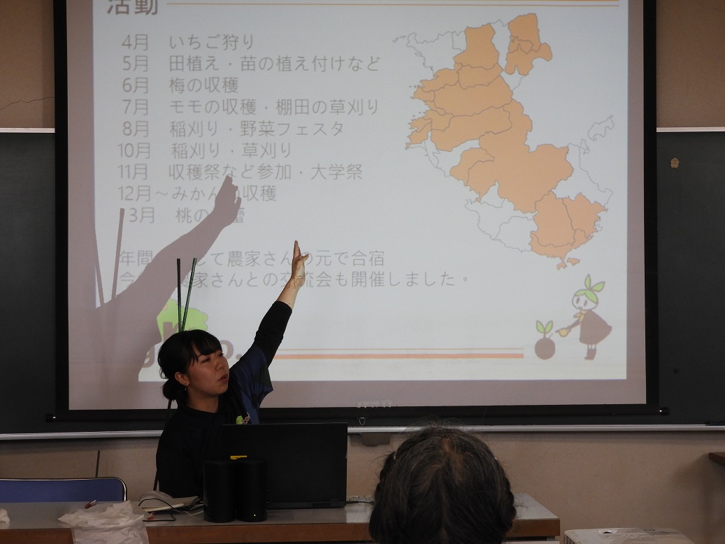 スクリーンを指す学生